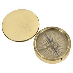 an old brass compass on a white background