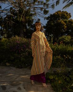 This riviera inspired caftan is the answer to glam layering. This exquisite garment is more than just a piece of clothing; it's a celebration of fabric in all its glory. Crafted with generous amounts of a brilliantly airy georgette and lots of love, this piece offers an airy fit designed to drape beautifully on all body types. Whether worn poolside for a day at the cabana or layered and adorned with your favorite accessories for a glamorous evening affair, it's a versatile wardrobe staple that e Bohemian Flowy V-neck Tunic, Flowy Bohemian V-neck Tunic, Bohemian V-neck Kurta For Spring, Bohemian Multicolor Maxi Kurta, Multicolor Long Bohemian Tunic, Hippie Tunic Kaftan For Spring, Long Bohemian Tunic For Spring, Flowy Festival Tunic, Chic Flowy Tunic Kaftan