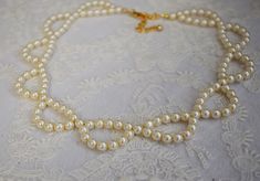 This necklace was inspired by an 1822 Fashion Plate. It's made with 7mm glass pearls in a lovely creamy shade. 16" long with a 3" extension chain. Elegant Beaded Chain Necklace, Elegant Cream Necklaces With Pearl Charm, Elegant Cream Necklace With Pearl Charm, Elegant Pearl White Necklace With Beaded Chain, Elegant Single Strand Cream Pearl Necklace, Elegant Pearl White Beaded Chain Necklace, Elegant Cream Single Strand Pearl Necklace, Elegant Cream Single Strand Necklace, Elegant Beaded Pearl Necklaces For Formal Events