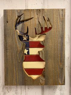 a deer head with an american flag painted on it's back and antlers