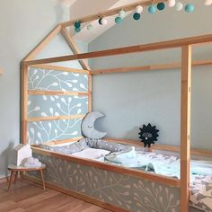 a child's bed made out of wood and painted with flowers on the side