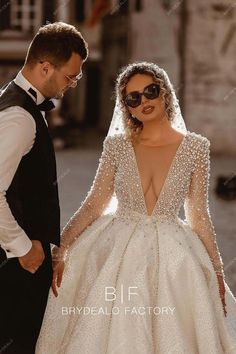 a man in a tuxedo standing next to a woman wearing a wedding dress