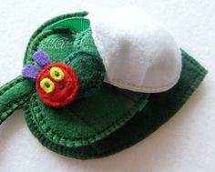 a close up of a small green object with a white hat on it's head