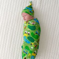 Infant swaddled in a Fairway Fun swaddle and hat set Swaddle Sets, Newborn Outfit, Lemonade Stand, Hole In One, Hat Set, Car Seat Cover, Play Mat, Burp Cloths, Outfit Set