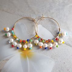 Rainbow earrings, colorful earrings, beach jewelry, big hoop earrings, modern jewelry, mothers day gift, freshwater pearl hoop earrings, wire wrapped earrings, cute earrings, summer jewelry, unique earrings, rainbow jewelry, 24K gold filled hoop. Modern trendy beach jewelry. These rainbow earrings look like a piece you might pick up on vacation. Wear them with everything from a T-shirt and jeans to your favorite swimsuit. HIGH QUALITY MATERIALS / SIZE 24-karat gold filled 20mm hoops wire wrapped Colorful Hoop Earrings For Summer, Colorful Hoop Summer Earrings, Rainbow Drop Earrings For The Beach, Rainbow Drop Earrings For Beach, Colorful Dangle Hoop Earrings For Summer, Colorful Drop Earrings For Beach, Fun Rainbow Earrings For Beach, Rainbow Earrings For Beach And Summer, Colorful Ear Wire Earrings For Beach