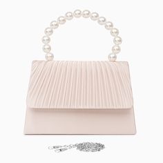 Crafted with a satin exterior, the Sienna Pearl String Handbag exudes a simple yet elegant aesthetic that speaks volumes about its refined design. Its craftsmanship is impeccable, reflecting a commitment to excellence that is second to none. Its design combines functionality with luxury, ensuring you can carry it effortlessly from day to night. This handbag is the perfect choice for those who demand the best! Now available in apricot and silver. Feminine Evening Bag With Top Carry Handle, Event Shoulder Bag With Detachable Strap, Feminine Evening Bag With Removable Pouch, Feminine Top Handle Satchel For Evening, Feminine Evening Shoulder Bag, Feminine Evening Shoulder Bag With Detachable Handle, Chic Satchel Bag With Pearl Handle, Elegant Top Handle Satchel For Party, Elegant Evening Box Bag With Dust Bag