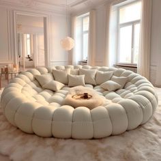 a large white circular couch sitting on top of a fluffy rug in a living room