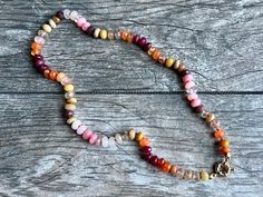 Desert sunset - this beautiful gemstone necklace was created with a variety of gemstones in sunset hues of red, orange, yellow and pink. Ruby, chalcedony, carnelian, agate, citrine, opal, quartz, rose quartz, yellow aquamarine and more are hand knotted on bright coral colored silk and finished with a gold-filled sailor clasp for you to add your favorite charms.  The gemstones are 7 to 8mm in diameter, which gives this piece a nice weight, and the process of hand knotting each gemstone individual Bohemian Pink Agate Necklace, One Of A Kind Multicolor Healing Necklaces, Pink Agate Gemstone Bead Necklace, Pink Agate Jewelry With Colorful Beads, Pink Opal Single Strand Beaded Necklace As Gift, Bohemian Pink Opal Necklace For Gifts, Artisan Multicolor Carnelian Necklace, Pink Opal Beaded Necklace For Gift, Spiritual Pink Opal Gemstone Necklace