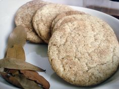 three cookies are on a plate with leaves