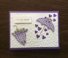 a card with an umbrella and hearts on it