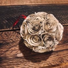 an origami flower bouquet made out of sheet music paper on a wooden table