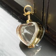 Gold Locket Necklace (mini size) Our mini gold lockets are the best way to store life's little treasures and wear them around your neck for eternity.  So easy to open and double-sided to contain two special photographs or a cherished memory item that can be viewed from both sides.  The lockets have a 5mm internal gap so you can even store crystals inside or some pills (daily medication if you are going on a trip, perhaps?). This beautiful Victorian style hand-crafted locket pendant holds a small memorial or keepsake for your loved one to cherish.  This is the perfect memorial gift to store the ashes of a late pet dog or cat, or maybe even some of their fur inside. To open and close the locket, simply screw or unscrew the silver nut.  All lockets in this section are approximately 1.5 inches Gold Spiritual Jewelry For Keepsake, Brass Locket Necklace With Charms For Keepsake, Brass Heart Charm Jewelry For Keepsake, Keepsake Brass Jewelry With Heart Charm, Gold Necklaces With Detachable Pendant For Keepsake, Gold Nickel-free Necklace For Memorial, Gold Charms Locket Necklace Keepsake, Gold Heart Charm Locket Necklace, Gold Round Locket Necklace With Heart Charm