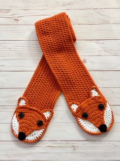 an orange knitted scarf with a fox design