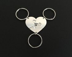 a heart shaped keychain with a dog's paw in the shape of a heart