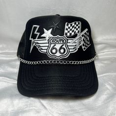 Route 66 and checkered flag Trucker Hat with Hat chain INCLUDED! Black Trucker Hat  5 Panel Trucker Hat  Foam Front  Mesh Back   Adjustable back  Perfect for: Indy 500 Racing Hat 4 th of July Mother's Day Fathers Day  Baby shower Summer hat Boat hat Trendy hat Patchy hat Custom Trucker Hats Unique Truckers Western style Cheap Black Trucker Hat With Embroidered Logo, Adjustable Cap For Biker Events, Black Biker Cap, Adjustable Black Motorcycle Hat, Black Motorcycle Cap, Baby Shower Summer, Hat Chain, 4 Th Of July, Boat Hat