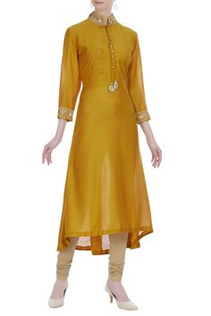 A bright ochre yellow bamber silk kurta to amp your ethnic wear wardrobe. It features embroidery on the collar and cuffs. It comes with beige churidar to complete the traditional look.
Mandarin collar
Loop button placket
Asymmetric hemline - Aza Fashions Ochre Yellow, Silk Kurta, Churidar, Ethnic Wear, Collar And Cuff, Mandarin Collar, Aza Fashion, Fashion Set, Three Quarter