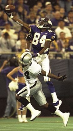 two football players are jumping in the air