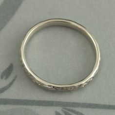 White Gold Skinny Flourish Band Women's Wedding Band Women's White Gold Band Vintage Style Band Antique Style Ring White Gold Wedding Band This is a slimmer version of our Flourish Le Femme band: https://www.etsy.com/listing/151251996 And our Flourish Wide: https://www.etsy.com/listing/179128813 At a dainty 2.4mm wide by 1.5mm thick, this is the perfect thinner wedding band or stacking ring. You simply can't do without it! Pair it with your other stacking rings or wear it alone as a symbol of yo White Gold Round Band For Wedding, White Gold Round Wedding Band, White Gold Wedding Ring With Decorative Band, Engraved Wedding Band Rings, Heirloom Engraved Bands For Wedding, Wedding Bands With Diamond Cut In Silver, Silver Wedding Bands With Diamond Cut, Silver Diamond Cut Wedding Bands, Silver Diamond Cut Bands For Wedding