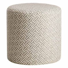 a white and grey ottoman with an intricate pattern