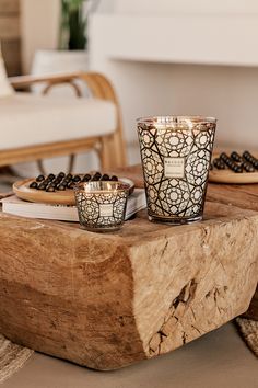 two candles sitting on top of a wooden table