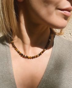 Tigers eye beaded necklace. This classic beaded necklace is made of genuine Tiger's eye stone and 14k gold filled donut beads and magnetic clasp. Ideal for layering, but looks great on its own too. Necklace length is 42 cm or 16.5 inches. Beads measure 6 mm. Handmade in Spain. Free shipment with registered trackable post. SPECIAL OFFERS: ✦ Special 10% OFF when you order 2 items!! Apply Coupon Code: SAVEMORE2 ✦Special 15% OFF when you order 3 or more items!! Apply Coupon Code: SAVEMORE3 You might Tigers Eye Beaded Necklace, Tigers Eye Jewelry Ideas, Gold Crystal Necklaces With Round Beads For Everyday, Everyday Beaded Necklaces With Natural Stones, Everyday Gemstone Beaded Necklaces, Everyday Round Beaded Necklaces With Natural Stones, Everyday Spiritual Brown Necklace, Everyday Gold Beaded Necklace With Natural Stones, Tigers Eye Jewelry