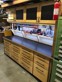 a large workbench with lots of drawers and cabinets