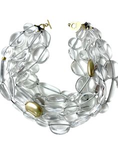 Medium-size glass-like irregular clear and gold beads are in a multistrand design for day or night.  The medium-sized beads resemble icicles with accent gold beads breaking the clear pattern. The necklace measures 21 IN/23 OZ. Elegant Single Strand Clear Necklace, Multi-strand Glass Jewelry For Party, Elegant Multi-strand Glass Beaded Necklaces, Elegant Crystal Beaded Necklaces With Clear Beads, Elegant Clear Beaded Necklace With Faceted Beads, Elegant Clear Faceted Beaded Necklaces, Elegant Clear Single Strand Beaded Necklace, Elegant Clear Crystal Beaded Necklaces, Elegant Clear Faceted Beaded Necklace