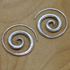 "Handmade Sterling Silver Spiral Earrings - Simple Rustic Thick Chunky swirl Tribal earrings ,\"fake Gauges\", For Women or Men Earrings Dimensions: Size: 1\" / 2.5cm - The thinner part is of the spiral is about 1mm (a normal earring's hook size), this part is about about 1.5\" / 4cm long. We also have similar versions of theses earrings: https://www.etsy.com/listing/480514617 https://www.etsy.com/listing/205519371 Weight: 0.265oz / 8gr Metal Purity: 95% Silver (Purer than 925 Sterling Silver) T Dope Jewelry, Spiral Earrings, Earrings Simple, Funky Jewelry, Jewelry Lookbook, Men Earrings, Party Jewelry, Jewelry Inspo, Simple Earrings