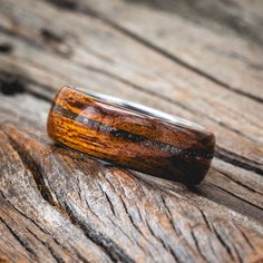 a wooden ring sitting on top of a piece of wood