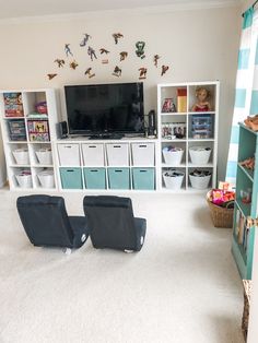 two black chairs sitting in front of a tv on top of a white carpeted floor