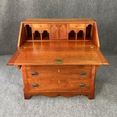 an old wooden desk with drawers on top