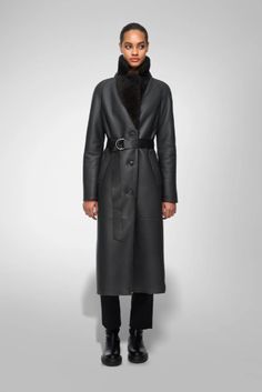 Women's Shearling Leather Coat In Black With Belted Waist Experience luxurious warmth with our women's shearling leather coat in black. Crafted from genuine sheepskin leather with a semi-aniline finish, this coat features a cozy faux shearling inner shell. The elegant fur collar and belted waist add a touch of sophistication, while the button closure and open hem cuffs offer a classic look. Designed with one inside pocket and two side pockets for practicality, this black coat is perfect for both style and comfort. Outer Shell: Genuine Leather Leather Type: Sheepskin Leather Finish: Semi-aniline Inner Shell: Faux Shearling Feature: Big Elegant Fur Collar, Belted Waist Closure Style: Button Collar Style: Fur Collar Cuffs Style: Open Hem Inside Pockets: One Outside Pockets: Two Side Pockets C Leather Shorts Women, Short Leather Skirts, Leather Jumpsuit, Shearling Vest, Studded Jacket, Sheepskin Jacket, Distressed Jacket, Western Jacket, Single Breasted Coat