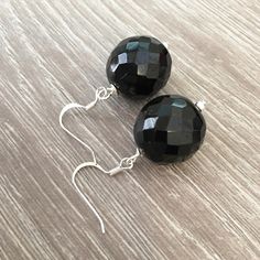 These handcrafted black onyx earrings are simply stunning! Silver fish hooks featuring a large 18mm round faceted black onyx gemstone and measuring 1.5 inches in length. Perfect for any formal occasion! Item is carefully packaged and shipped via USPS in a sturdy protective mailer. Check out more fabulous jewelry and enter my shop here: https://www.etsy.com/shop/jewelbytessyla View the positive feedback I've received from customers and check out some beautiful art prints for nursery and home at m Prints For Nursery, Abalone Earrings, Black Onyx Earrings, Black Earrings Dangle, Fish Hooks, Silver Fish, Yellow Gemstones, Jade Earrings, Onyx Earrings