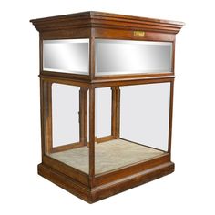 an old fashioned wooden display case with mirrors on the front and side windows, isolated against a white background