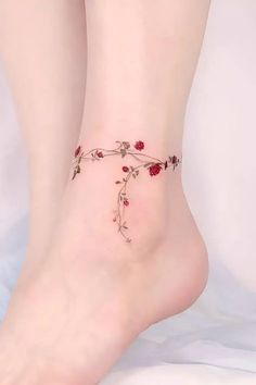 a close up of a person's foot with flowers on it