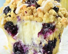 a close up of a blueberry crumb muffin on a white paper towel