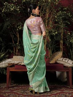 Introducing our exquisite "pretty teal green zari weaving silk festival wear saree with blouse" - the perfect outfit to make a statement at any festive occasion. This stunning teal-green silk saree features intricate sequin and embroidered work that adds a touch of elegance and charm to your look. Paired with a pink silk blouse with zari weaving work, this saree set is sure to turn heads wherever you go.
The 5.50-meter saree and unstitched blouse material allow for customization and a perfect fi Green Pre-draped Saree With Meenakari For Puja, Festive Green Pre-draped Saree With Zari Weaving, Festive Turquoise Pre-draped Saree, Green Semi-stitched Pre-draped Saree With Meenakari, Green Bollywood Pre-draped Saree With Meenakari, Green Pre-draped Saree With Zari Weaving For Diwali, Green Paithani Silk Pre-draped Saree With Self Design, Bollywood Banarasi Silk Blouse With Meenakari, Festive Banarasi Silk Blouse With Meenakari Details