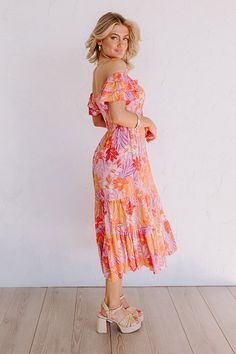 - Enjoy a laid back day in the sun in this darling dress! - Material with an orange, pink, and purple hued botanical print - A built-in lining ending mid-thigh - An elastic scoop neckline - Short flutter sleeves - A smocked upper back - Hidden side pockets - A flowy yet flattering silhouette that ends in a midi length hemline Back Day, Darling Dress, Purple Hues, Botanical Print, Pink And Purple, Dress Material, Flutter Sleeves, Orange Pink, Botanical Prints