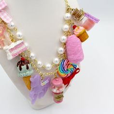 This kawaii statement necklace is called Pink Candy Shop and is a perfect cute charm jewelry gift for any woman in your life including your best friend (or yourself, let's be honest). This piece has been handmade from resin, clay and high quality metal components and features hand painted charms for a quality piece that will be a cute go-to in any charm lovers jewelry collection! Details & Measurements:-Handmade Necklace-High quality glass pearls-Hand-painted charms made from resin & polymer clay-Gumball machine has free floating beads inside! (note it is partially made from glass and fragile)-Choose Gold or Silver Finish -Choose 5, 7 or 9 charms (see list below to find out what charms come on each option)-Charms are chunky and are 1-2" in size (2.5-5cm)-19" (47.5cm) total Necklace Length- London Birthday, Lovers Jewelry, Perfect Cute, Chunky Bracelet, Resin Clay, Gold Charm Necklace, Ice Cream Truck, Ring Pendant Necklace, House Gifts