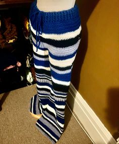 the legs of a woman wearing blue and white striped pants