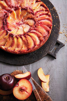 A plum-topped financier cake on a cutting board beside sliced purple plums for a post on the best plum financier recipe Plum Cake Recipe, Cornmeal Cake, Plum Tart, Summer Baking, Plum Cake, Sweet Ideas, Watermelon Recipes, Peach Recipe