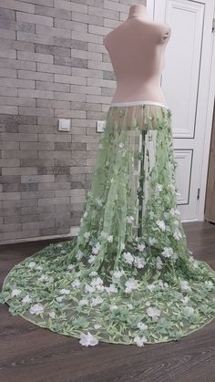 Flower embroidered light green tulle detachable wedding skirt with train - an elegant adding to your wedding gown can be matched with different styles wedding gowns and tops. Also, the skirt can be ordered in full, with Royal satin underneath skirt, Tulle crinoline and Lining. Please select all your preferred options and indicate your size at checkout. Kindly note that this listing is for the skirt presented in the first pictures. In case you are interested to buy one of optional items from the Detachable Wedding Skirt, Wedding Overskirt, Bridal Skirt Separate, Wedding Tops, Train Skirt, Wedding Train, White Flower Wedding, Cottagecore Wedding, Skirt Tulle