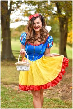 a woman dressed as snow white holding a basket