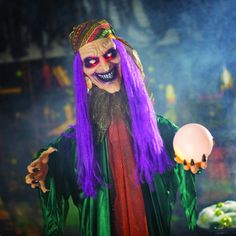 a man with purple hair and makeup holding a white ball in his hand while wearing a costume