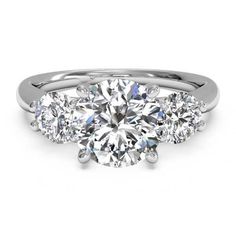 three stone engagement ring in white gold with diamonds on the sides and an oval diamond center