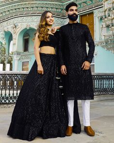 Menswear:- Readymade Faux Georgette Kurta set in Black This Chinese Collar and Full Sleeves attire is Enhanced with Pockets, Resham and Sequins Work Lehenga Choli:-Readymade Faux Georgette Lehenga in Black This attire with Shantoon and Cotton Lining is Enhanced with Fancy Tassels, Resham and Sequins Work Available with a Sleeveless Faux Georgette Black Choli Crafted in Round Neck and a Faux Georgette Dupatta in Black The Choli and Lehenga Lengths are 14 and 42 inches respectively Please refer re Black Sequin Kurta Men, Formal Festive Set With Unstitched Blouse, Eid Reception Party Wear Sets, Black Palazzo Set For Diwali Party, Black Party Wear Palazzo Set For Festive Occasions, Black Palazzo Set For Festive Party Wear, Black Palazzo Set For Party, Black Lehenga For Formal Festivals, Black Bollywood Style Palazzo Set For Party