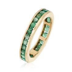 a gold ring with green stones