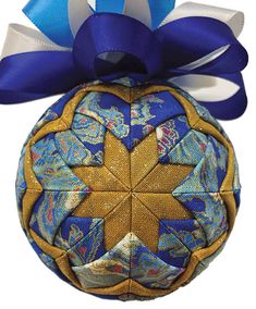 a blue and gold ornament with a bow on it