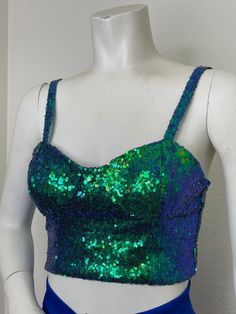 This sequin tank top is a perfect statement piece to add a some shine to any look. Style with high waisted pants or mini skirt. This top has stretch for a great for.  -Fully Lined  -Stretch Sequin Fabric  -Pull On -Machine Washable/ Hang Dry -Made in Los Angeles Green Crop Top Tank For Night Out, Green Stretch Sequined Tops, Green Sequined Stretch Tops, Sleeveless Sequined Crop Top For Party, Glamorous Sleeveless Sequined Crop Top, Glamorous Fitted Crop Top Tank Top, Green Sleeveless Crop Top For Party, Fitted Contrast Sequin Crop Top For Party, Sleeveless Green Crop Top For Party