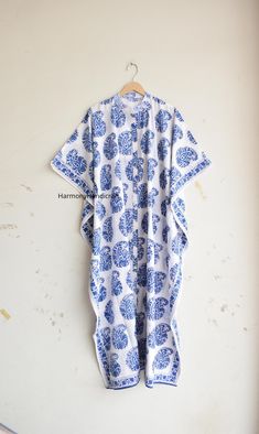 This hand block print Kaftan Is made From incredibly soft and lightweight cotton and is versatile for many occasions. It is so free flowing that it will make you feel as you are not wearing anything at all. The beauty of Front open kaftan is that they will fit everyone. The perfect floral print Kaftan is used to Lounge Wear, Resort Wear, Party Dress, beach Cover up, House Working Dress and use for a dinner party or just slip into in on a beautiful summer morning. This particular beauty has a Jap Bohemian Blue Printed Kaftan, Bohemian Blue Kaftan With Printed Motifs, Blue Summer Kaftan With Printed Motifs, Blue Printed Kaftan For Summer, Blue Kaftan With Printed Motifs For Summer, White Bohemian Kimono For Home, Blue Floral Print Cotton Kaftan, Blue Floral Cotton Kaftan, Blue Cotton Kaftan With Floral Print